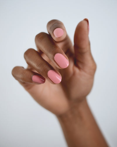 peachy pink nail polish hand swatch on Medium skin tone