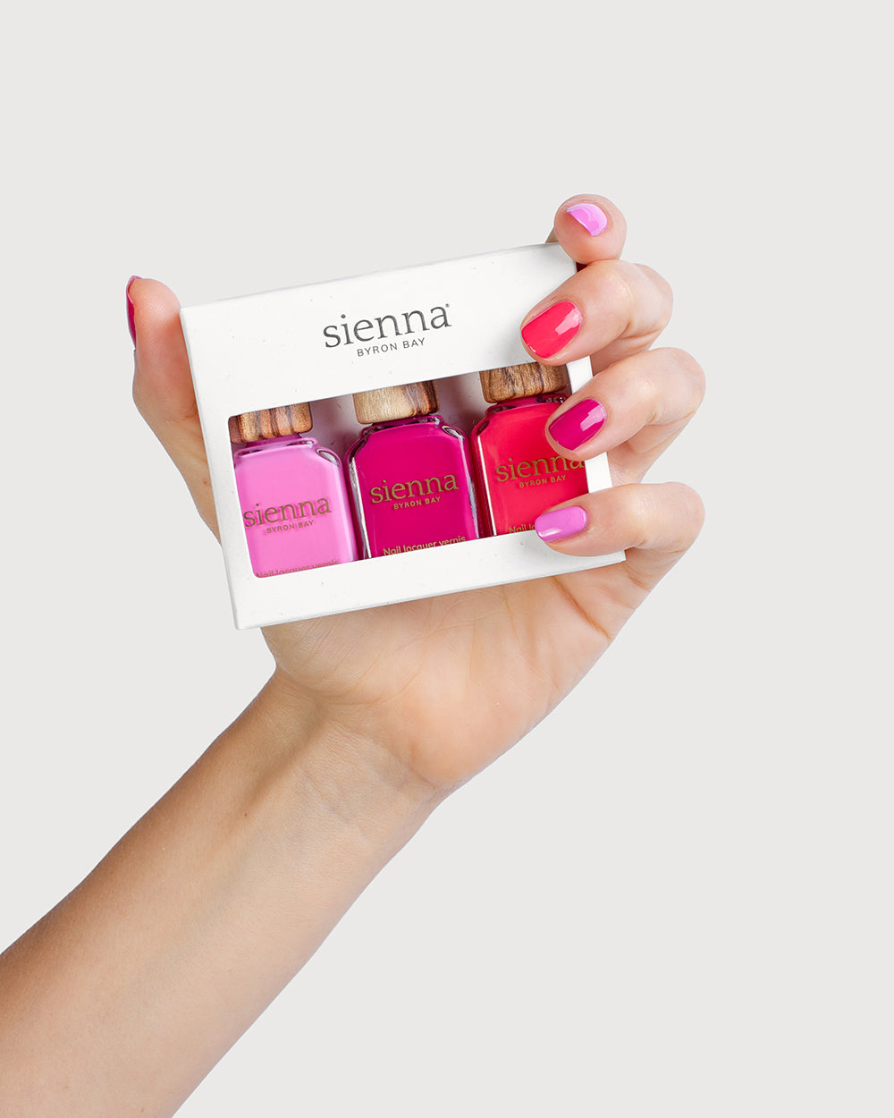 Fair Skin Tone Hand holding the crush trio pack with painted nails