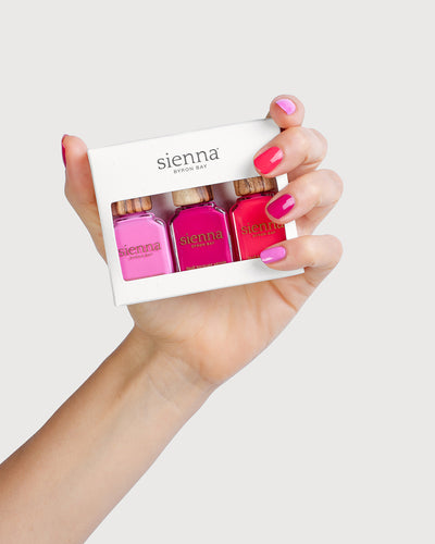 Fair Skin Tone Hand holding the crush trio pack with painted nails